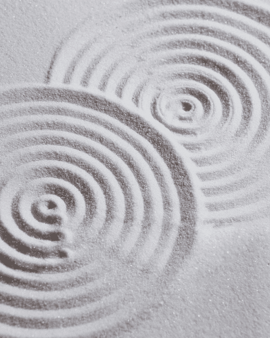 Concentric ripples raked into a zen sand garden